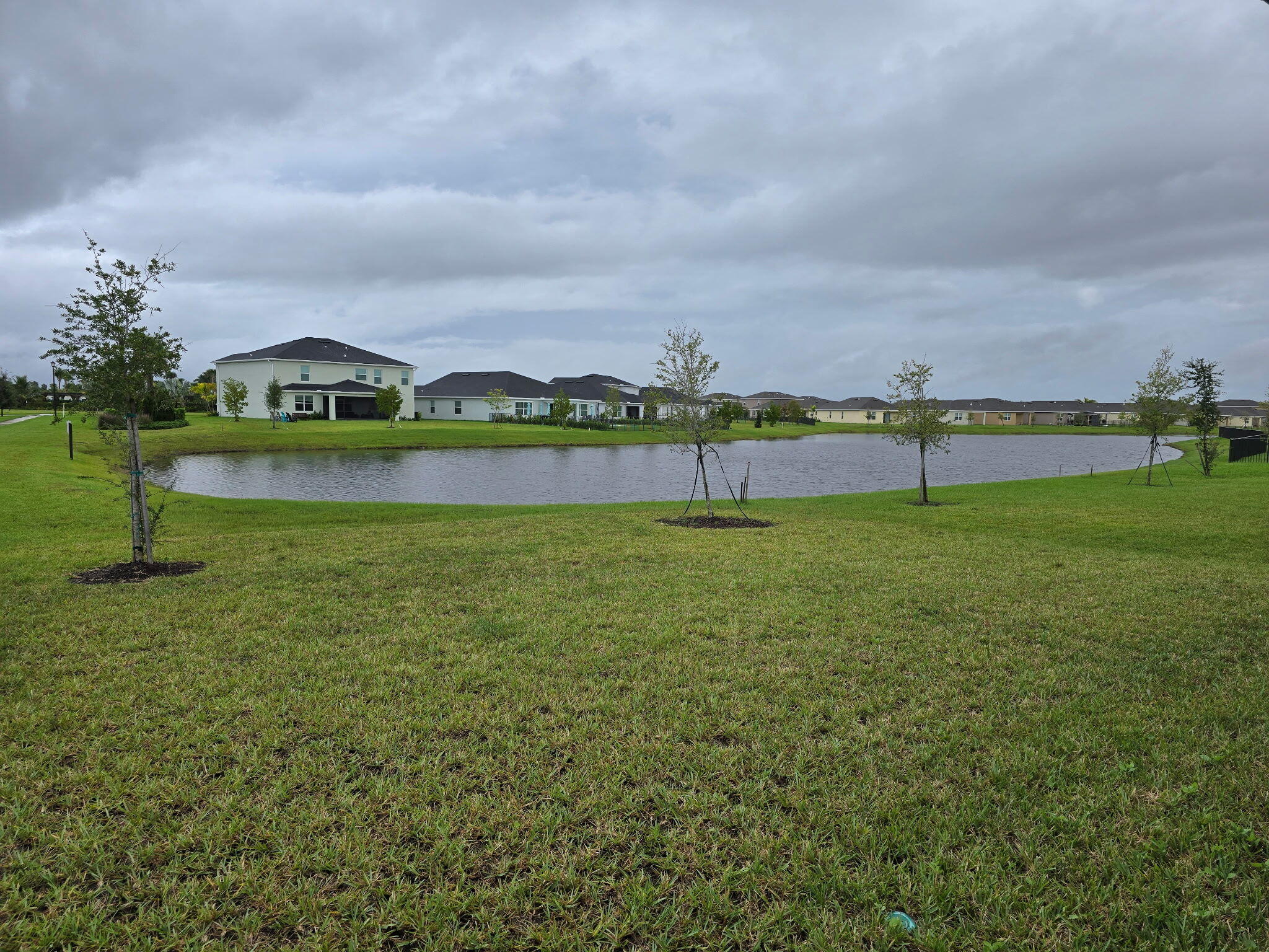 9725 Southwest Triton Way Port Port St. Lucie, FL 34987 - Photo 12 of 12 a view of a lake with houses in the back