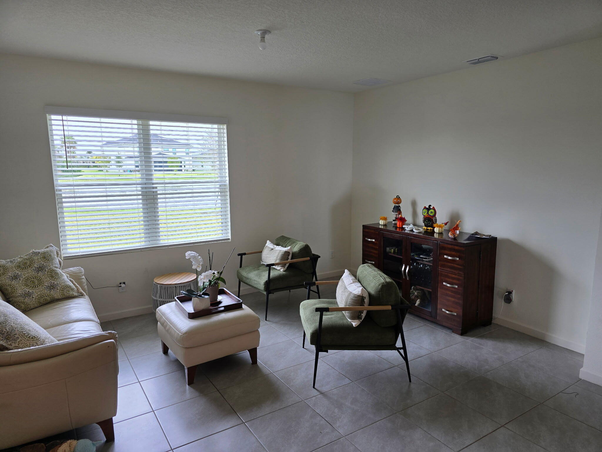 9725 Southwest Triton Way Port Port St. Lucie, FL 34987 - Photo 6 of 12 a living room with furniture and a window