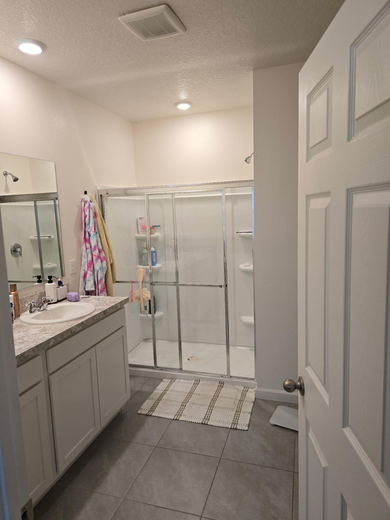 9725 Southwest Triton Way Port Port St. Lucie, FL 34987 - Photo 7 of 12 a bathroom with a sink and a mirror