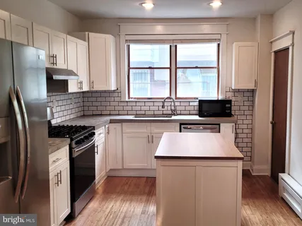 a kitchen with stainless steel appliances a refrigerator stove and sink