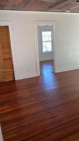 a view of a room with wooden floor