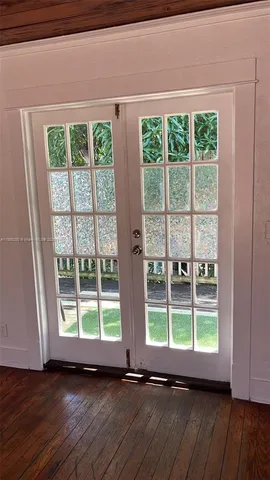 a view of backyard with a large window and plants