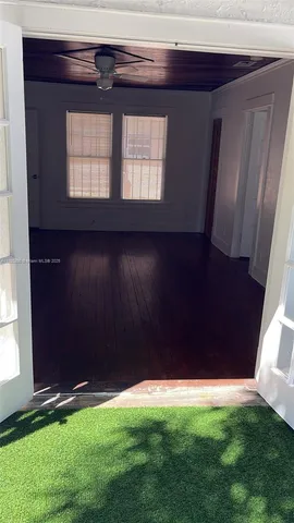 a view of backyard with a deck and a garden