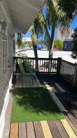 a view of a porch with furniture and garden