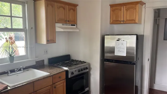 a kitchen with a stove and a refrigerator