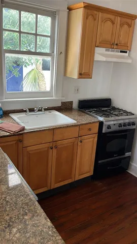 a kitchen with stainless steel appliances granite countertop a stove a sink and a microwave