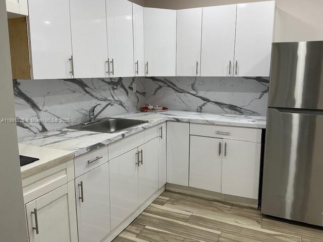 922 Northwest 2nd Street, Unit 1 Miami, FL 33128 - Photo 12 of 26 a kitchen with white cabinets and white appliances