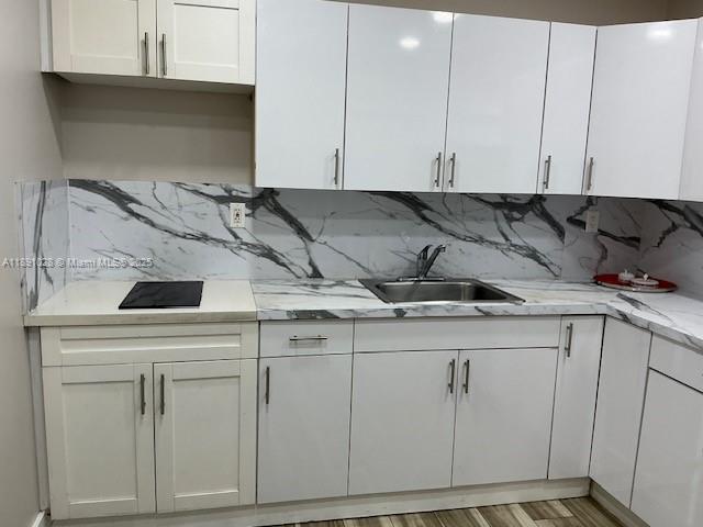 922 Northwest 2nd Street, Unit 1 Miami, FL 33128 - Photo 13 of 26 a kitchen with white cabinets