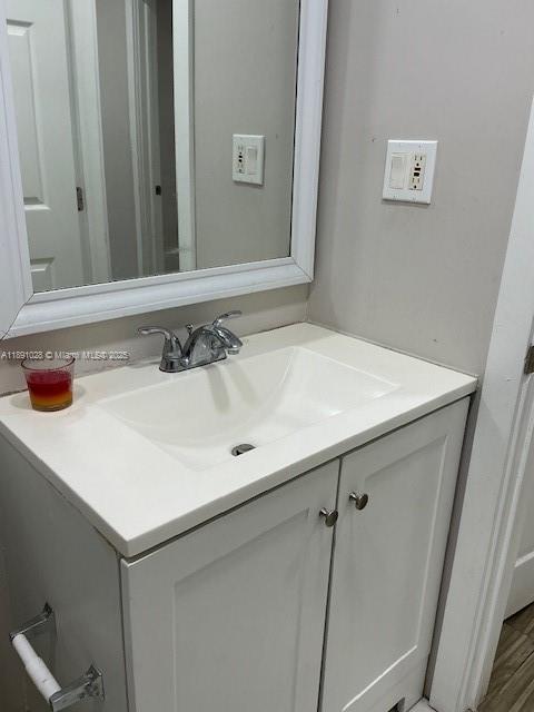 922 Northwest 2nd Street, Unit 1 Miami, FL 33128 - Photo 20 of 26 a bathroom with a sink and a mirror