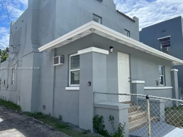 a front view of a house with plants