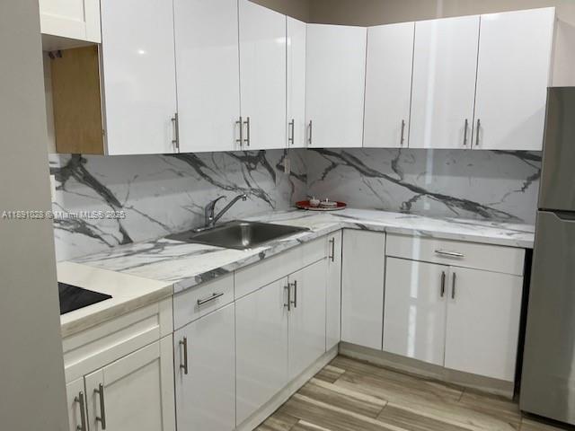 922 Northwest 2nd Street, Unit 1 Miami, FL 33128 - Photo 22 of 26 a view of a kitchen with white cabinets