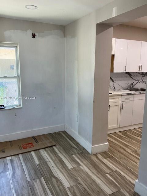 922 Northwest 2nd Street, Unit 1 Miami, FL 33128 - Photo 23 of 26 a view of kitchen with wooden floor and cabinets