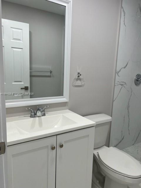 922 Northwest 2nd Street, Unit 1 Miami, FL 33128 - Photo 7 of 26 a bathroom with a sink toilet and mirror