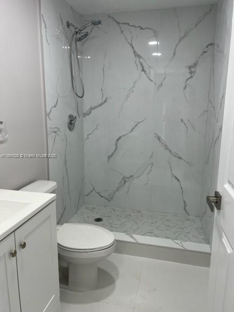922 Northwest 2nd Street, Unit 1 Miami, FL 33128 - Photo 8 of 26 a white toilet sitting next to a bath tub