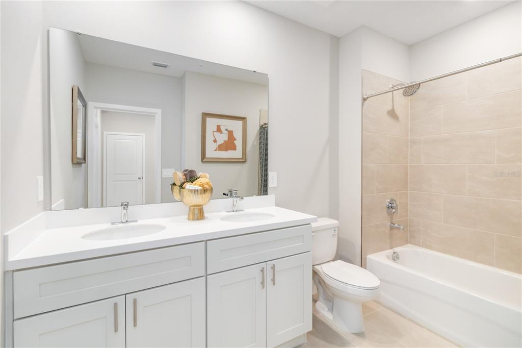 1129 Orange Trailside Way Ocoee, FL 34761 - Photo 23 of 31 a bathroom with a sink a toilet and shower