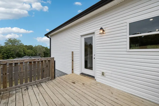 a balcony with wooden floor and fence