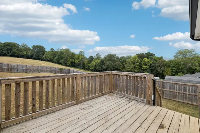 a view of a terrace with yard and mountain view in back