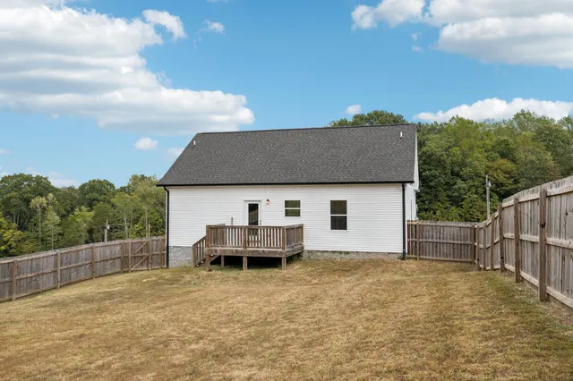 a backyard of a house with wooden fence