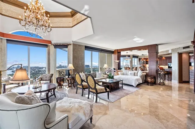 a living room with furniture and a chandelier
