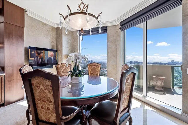 a bedroom with a bed chandelier and a window