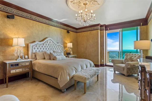 a bedroom with a bed and a flat tv screen on dresser