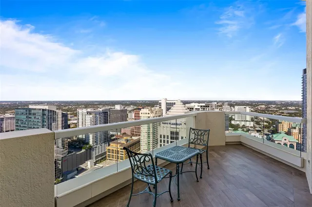 a bedroom with a bed and a lamp with the dresser