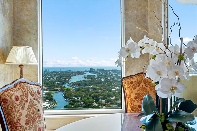 a living room with furniture a rug and a chandelier
