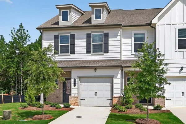 a front view of a house with garden