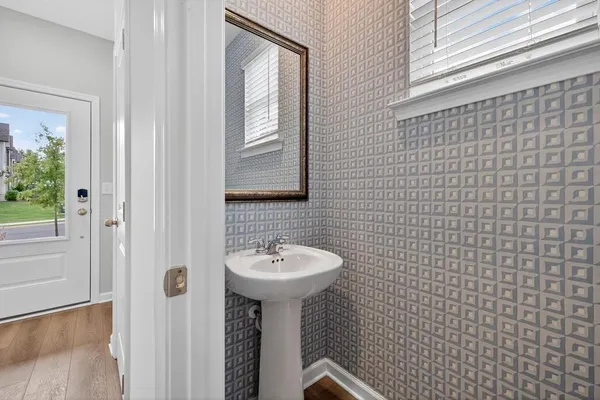 a bathroom with a sink a mirror and shower