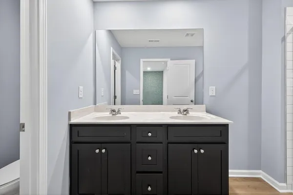 a bathroom with double sink and mirror