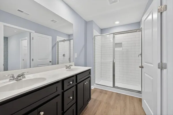 a bathroom with a double vanity sink and mirror