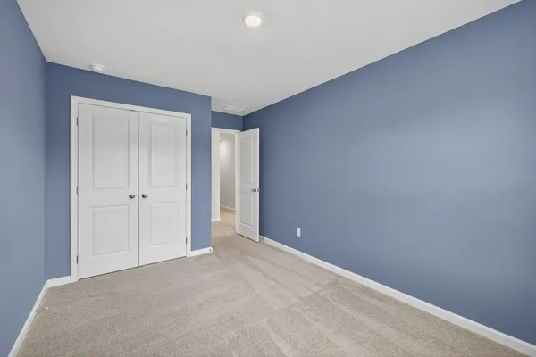 a view of an empty room and closet area