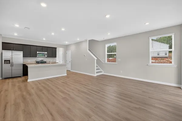 a view of kitchen with wooden floor electronic appliances and window