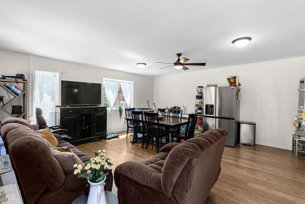 3340 Skytrail Ranch Road Jamul, CA 91935 - Photo 29 of 38 a living room with furniture a flat screen tv and kitchen view