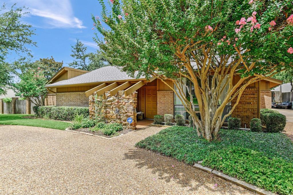 Mid-century modern home featuring brick siding and roof with shingles