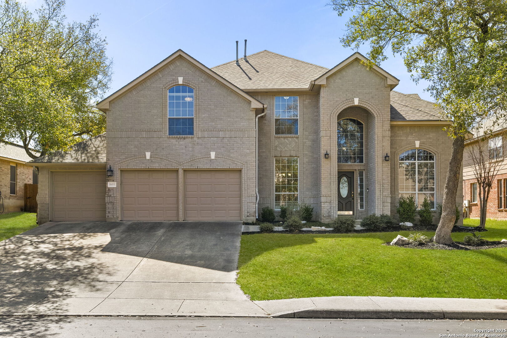 a front view of a house with a yard and garage