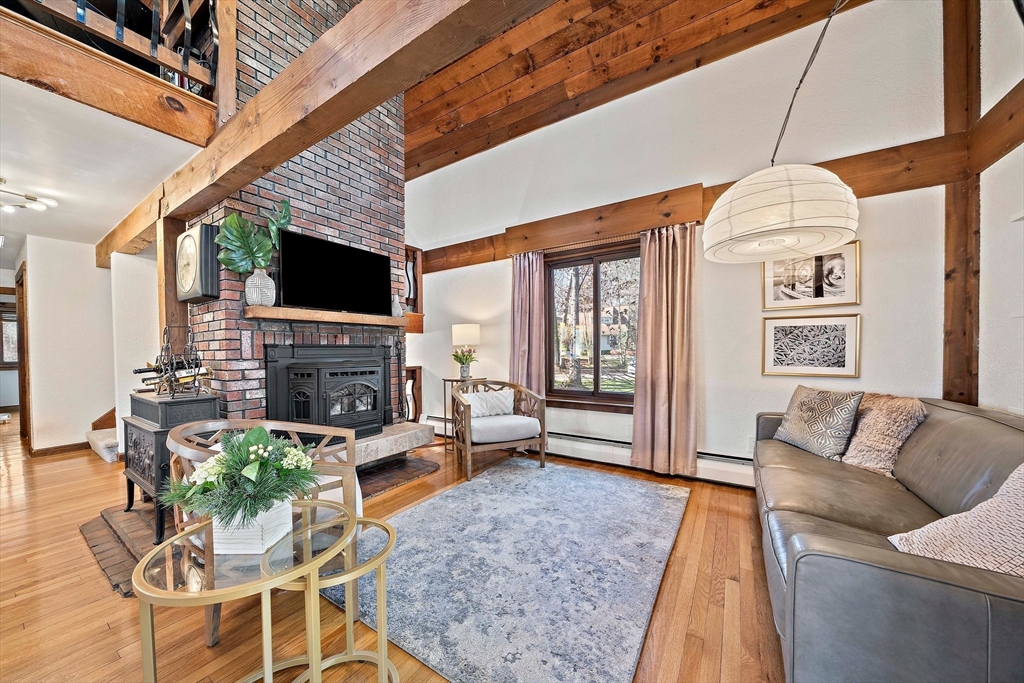 24 Pammys Path Easton, MA 02356 - Photo 12 of 39 a living room with furniture a fireplace and a flat screen tv
