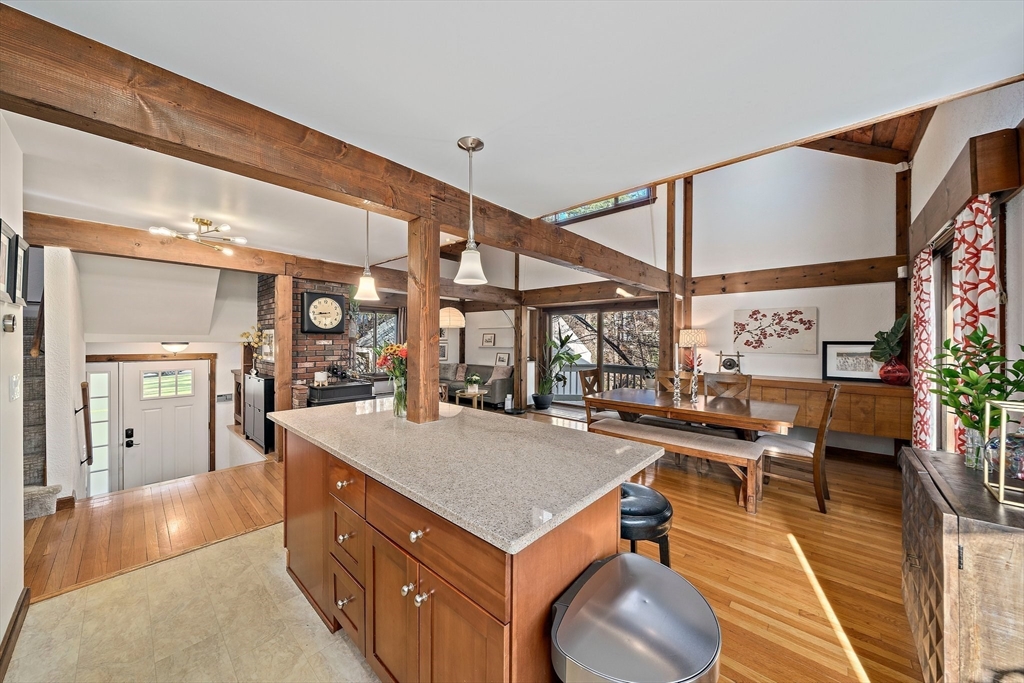 24 Pammys Path Easton, MA 02356 - Photo 16 of 39 a living room with a table chairs and a kitchen view