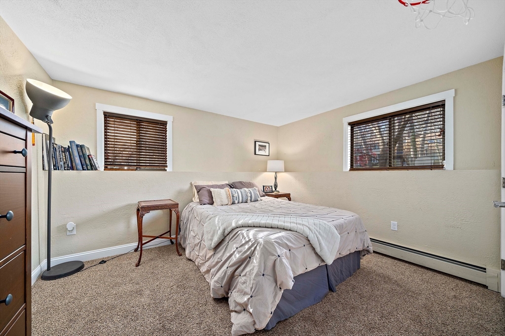 24 Pammys Path Easton, MA 02356 - Photo 31 of 39 a bedroom with a bed a mirror and a window