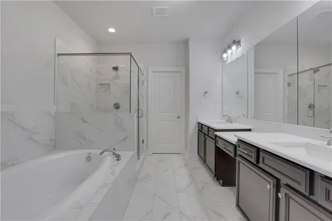 a bathroom with a bathtub and a shower