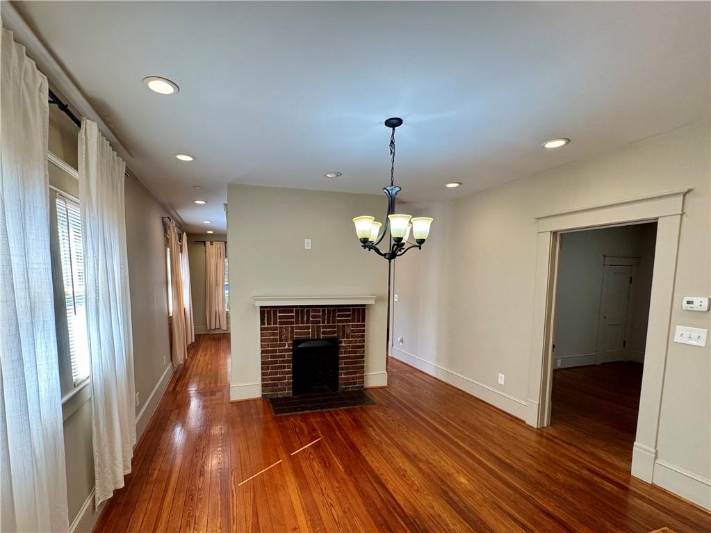 2482 Maple Street East Point, GA 30344 - Photo 11 of 39 a view of a livingroom with a fireplace wooden floor and chandelier