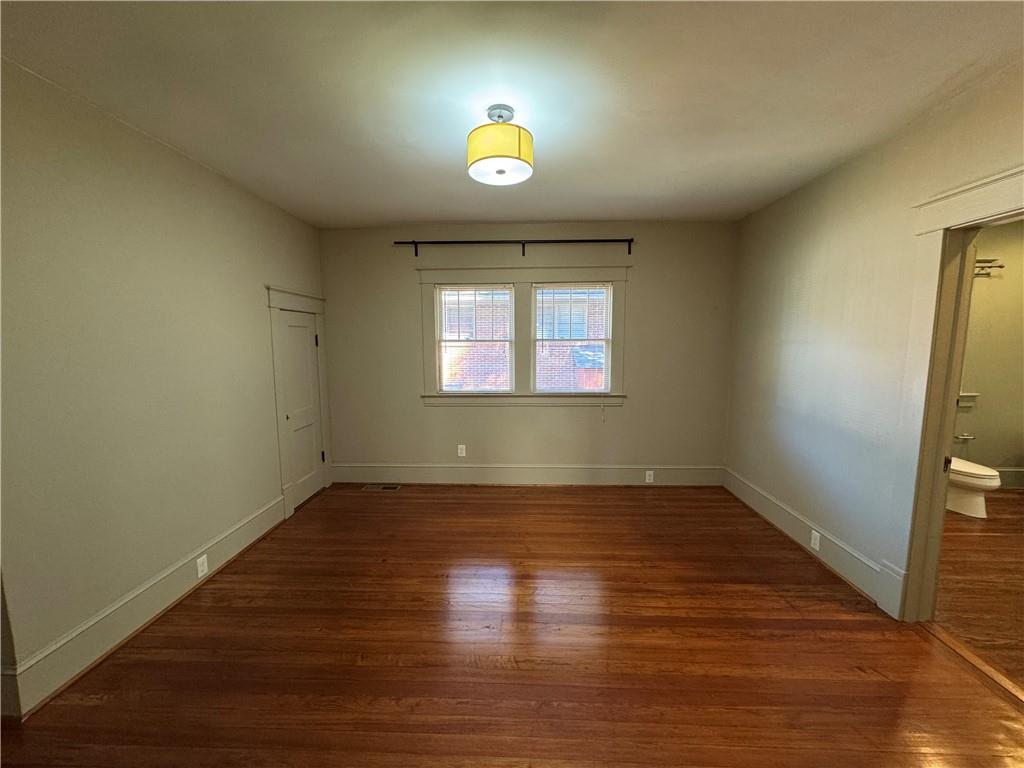 2482 Maple Street East Point, GA 30344 - Photo 19 of 39 a view of an empty room with wooden floor and a window
