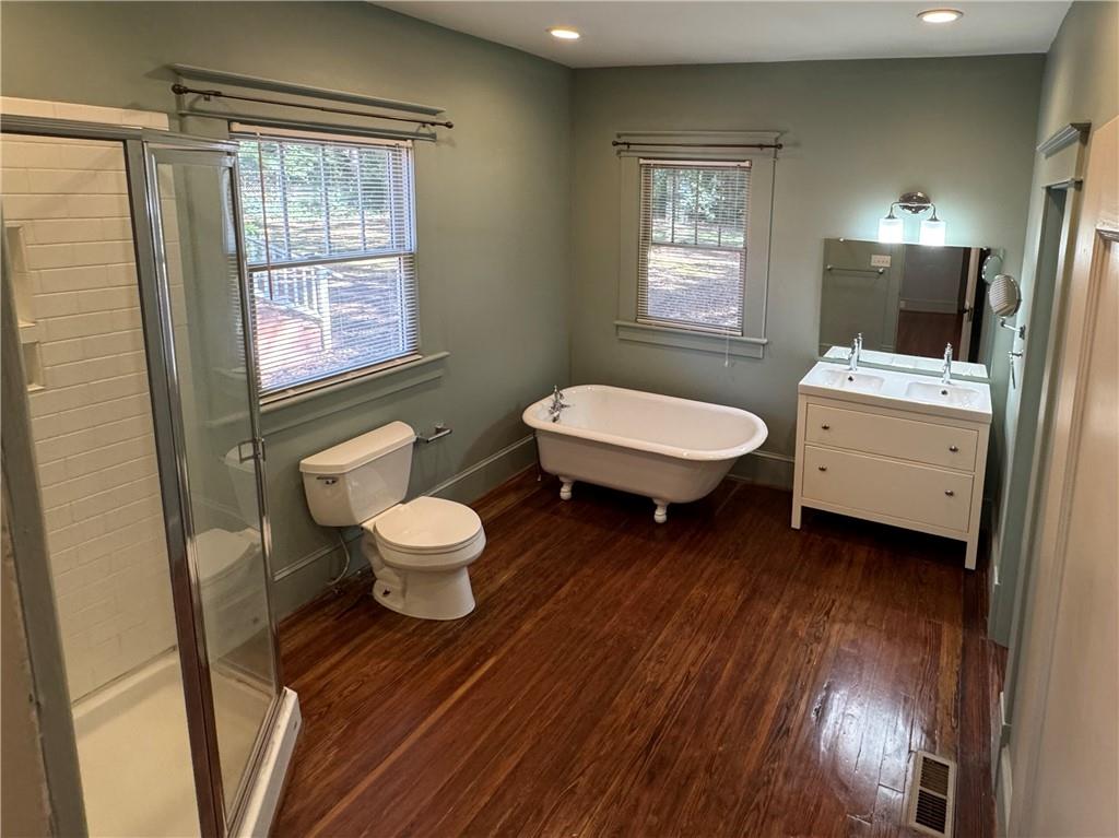 2482 Maple Street East Point, GA 30344 - Photo 23 of 39 a bathroom with a toilet a sink and mirror