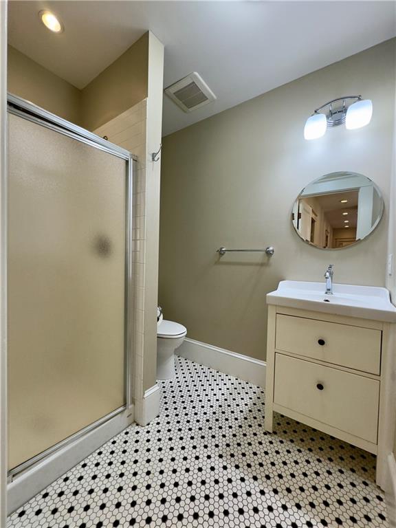 2482 Maple Street East Point, GA 30344 - Photo 30 of 39 a bathroom with a sink a toilet a shower and a mirror