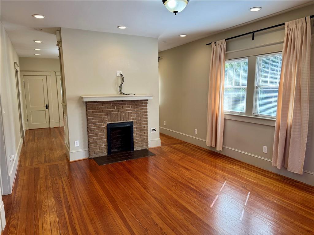 2482 Maple Street East Point, GA 30344 - Photo 3 of 39 a view of a livingroom with wooden floor and a fireplace