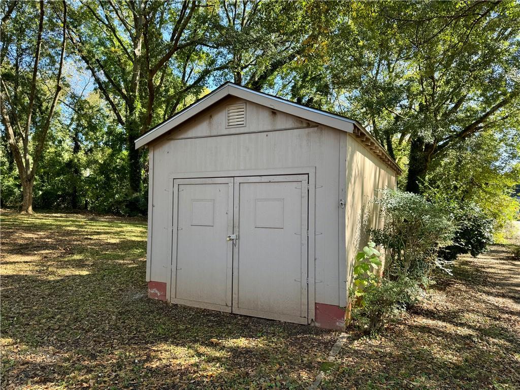 2482 Maple Street East Point, GA 30344 - Photo 37 of 39 a view of a small house with a tree in the yard