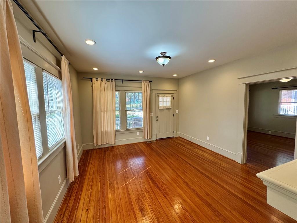 2482 Maple Street East Point, GA 30344 - Photo 5 of 39 a view of an empty room with wooden floor and a window