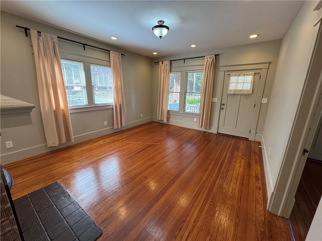 2482 Maple Street East Point, GA 30344 - Photo 6 of 39 a view of an empty room with wooden floor and a window