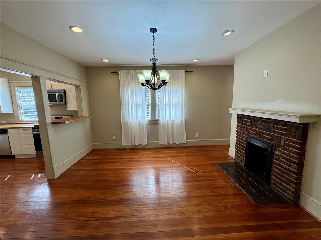 2482 Maple Street East Point, GA 30344 - Photo 10 of 39 a view of a livingroom with wooden floor a fireplace and window