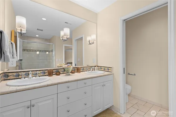 a bathroom with a double vanity sink and a mirror